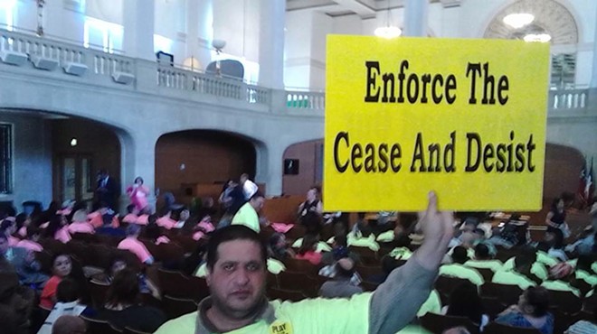 A Yellow Cab driver protests ride-share companies Uber and Lyft during a 2014 summer committee meeting.
