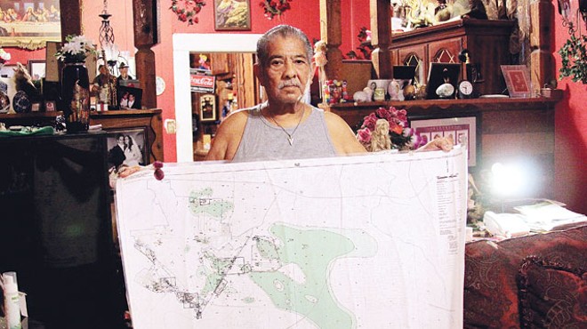 Toxic Triangle resident Robert Alvarado with a map of the contaminated groundwater plume.