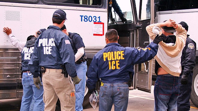 ICE agents arrest a suspect during a raid.