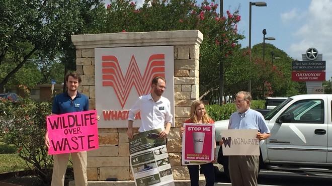 Luke Metzger (second from left) and other members of Environment Texas hold signs in front of Whataburger's S.A. headquarters.