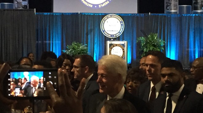 President Bill Clinton makes his entrance at the NAACP's gala.