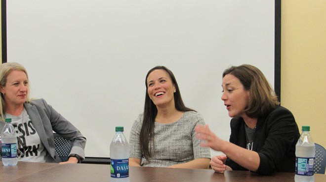 Lucinda Guinn (left) and Gina Ortiz Jones (center) listen to Tiffany Muller make a point during Friday's panel discussion.