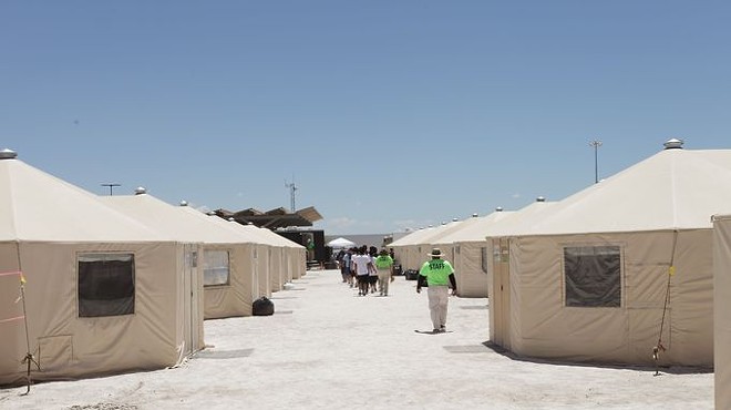 Staff and detainees walk between the tents inside the Tornillo, Texas, detention center for immigrant children, which closed earlier this year.