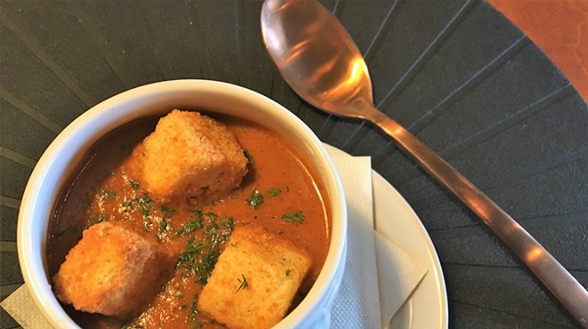 Roasted tomato soup, served with house-made croutons, is among Spoon’s familiar but well-executed dishes.