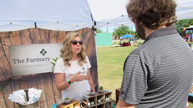 Carolyn Leeper of the Farmacy Botanical Shop discusses her product line at an outdoor mar- ket on the South Side.