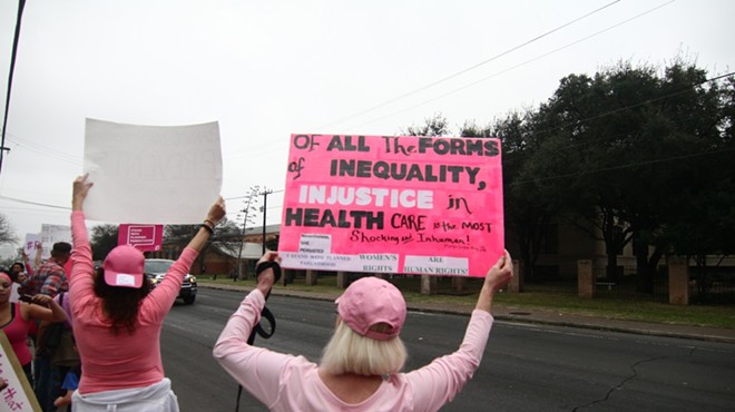 Protesters hold signs at a pro-Planned Parenthood rally in San Antonio.