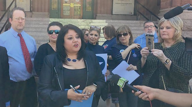 Bexar County Democratic Party Chairwoman Monica Alcantara speaks to the press outside the Bexar County Courthouse.