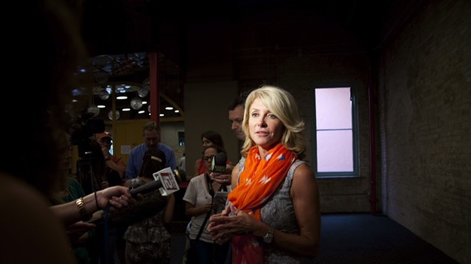 Wendy Davis speaks with reporters at a #StandWithTXWomen rally.