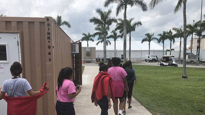 Unaccompanied minors walk inside a facility supervised by the Office of Refugee Resettlement in Homestead, Florida.