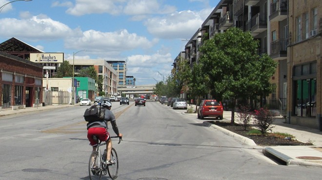 A cyclist pedals north from downtown on Broadway.