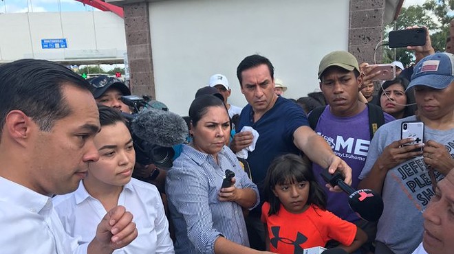Julián Castro speaks with asylum seekers waiting in a camp across from Brownsville.