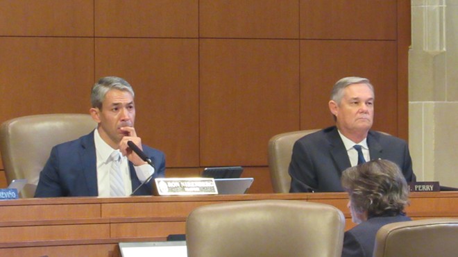 Mayor Ron Nirenberg (left) and Councilman Clayton Perry listen to a speaker at Thursday's meeting. Nirenberg championed the Climate Action & Adaption Plan, while Perry cast the sole vote against it.