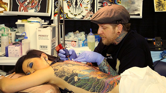 Jedidiah Reid working at a past Alamo City Tattoo Show.