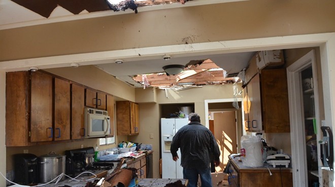 Adrian Venegas stands in what's left of his kitchen.