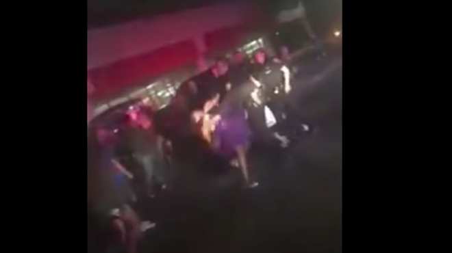 While the video's grainy, the girl's head can be seen reeling back after an officer extends their arm