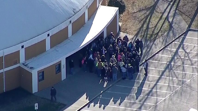 Parents gather outside of an Italy High School building Monday morning.