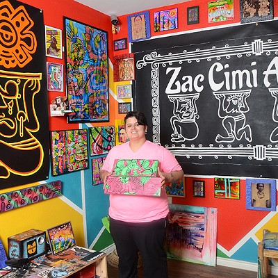 Nina Donley surrounded by her artwork at her West Side gallery, Zac Cimi Arte.