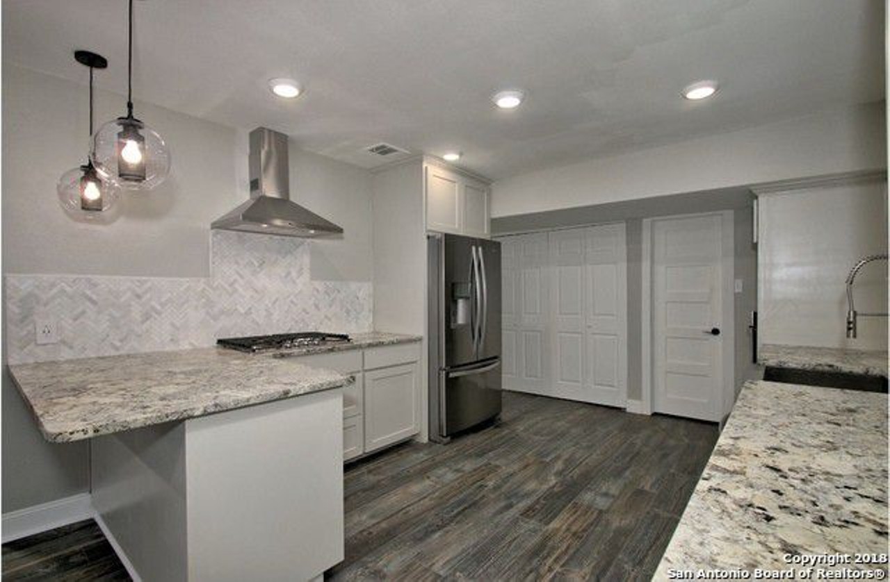 The kitchen features all-new appliances, including a commercial grade stove and refrigerator.