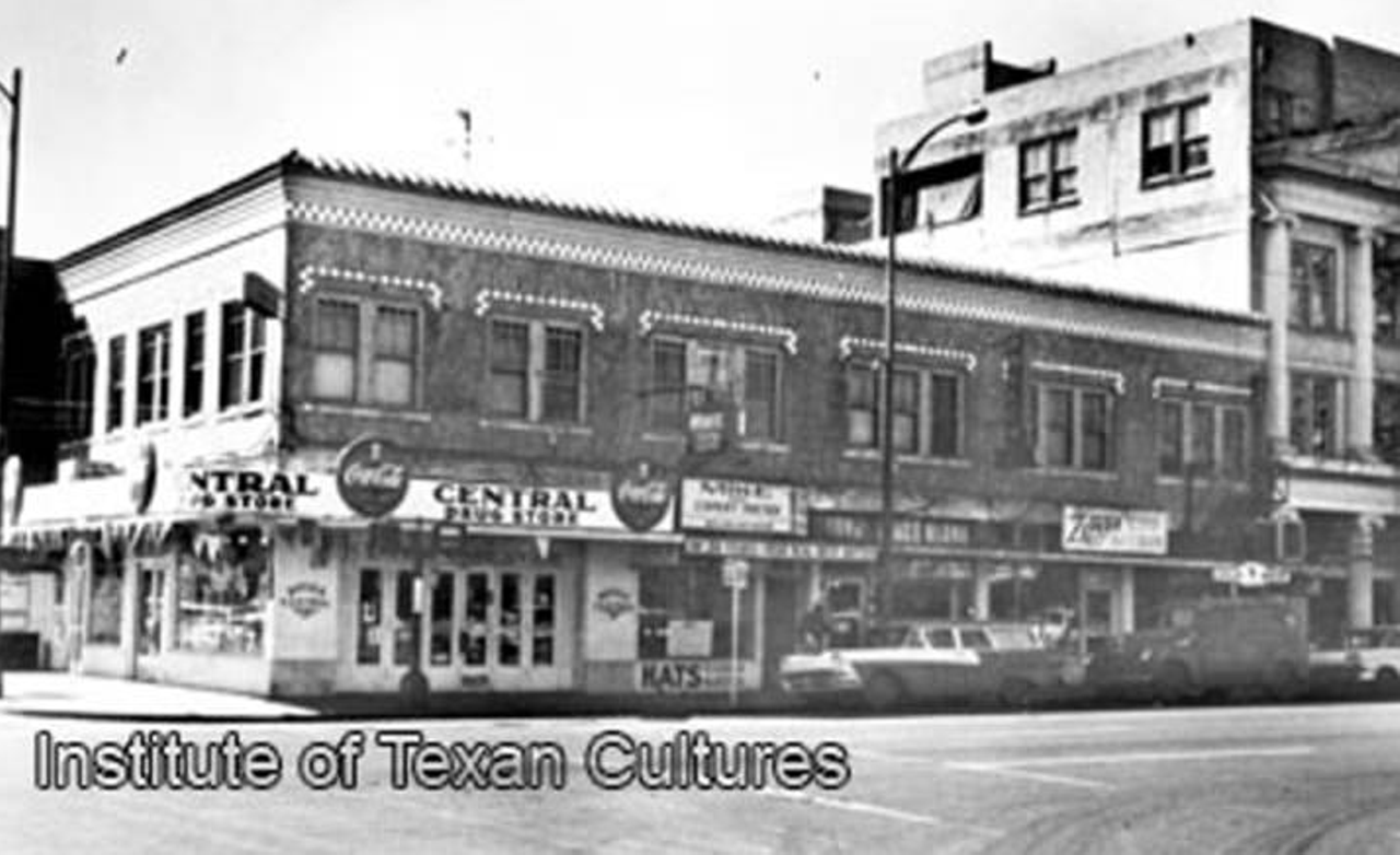 This 1960 photograph shows Central Drug Store, located on the southwest corner of Dolorosa and South Laredo streets. You can also spot Mike the Expert Hatter and Zepeda Radio & Television housed in this two-story brick building.
