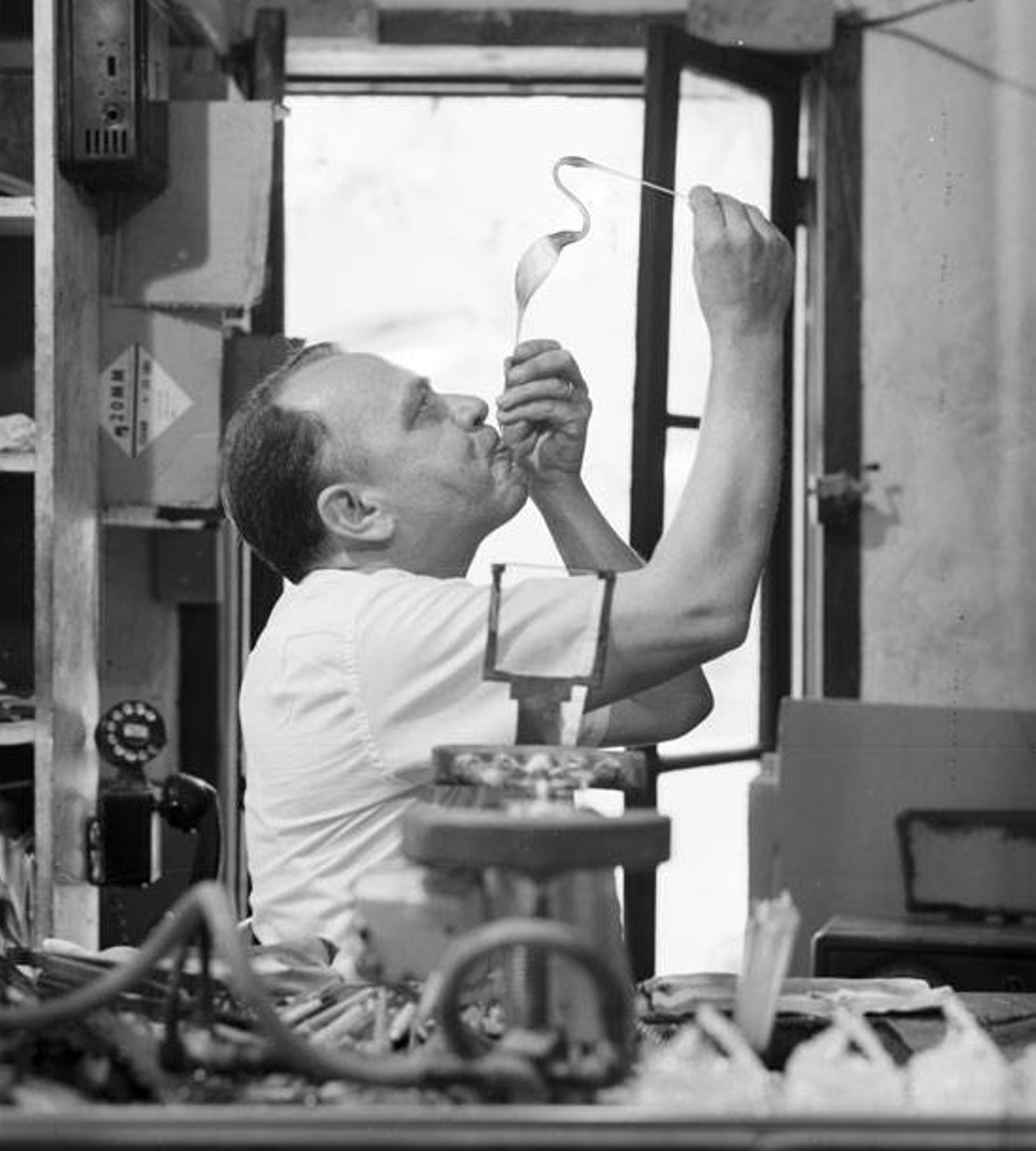 Lawrence "Larry" Williams can be seen blowing glass, which was his business. He operated the shop for 60 years out of La Villita, though he took just a brief break during World War II to serve as a radio operator in the military.