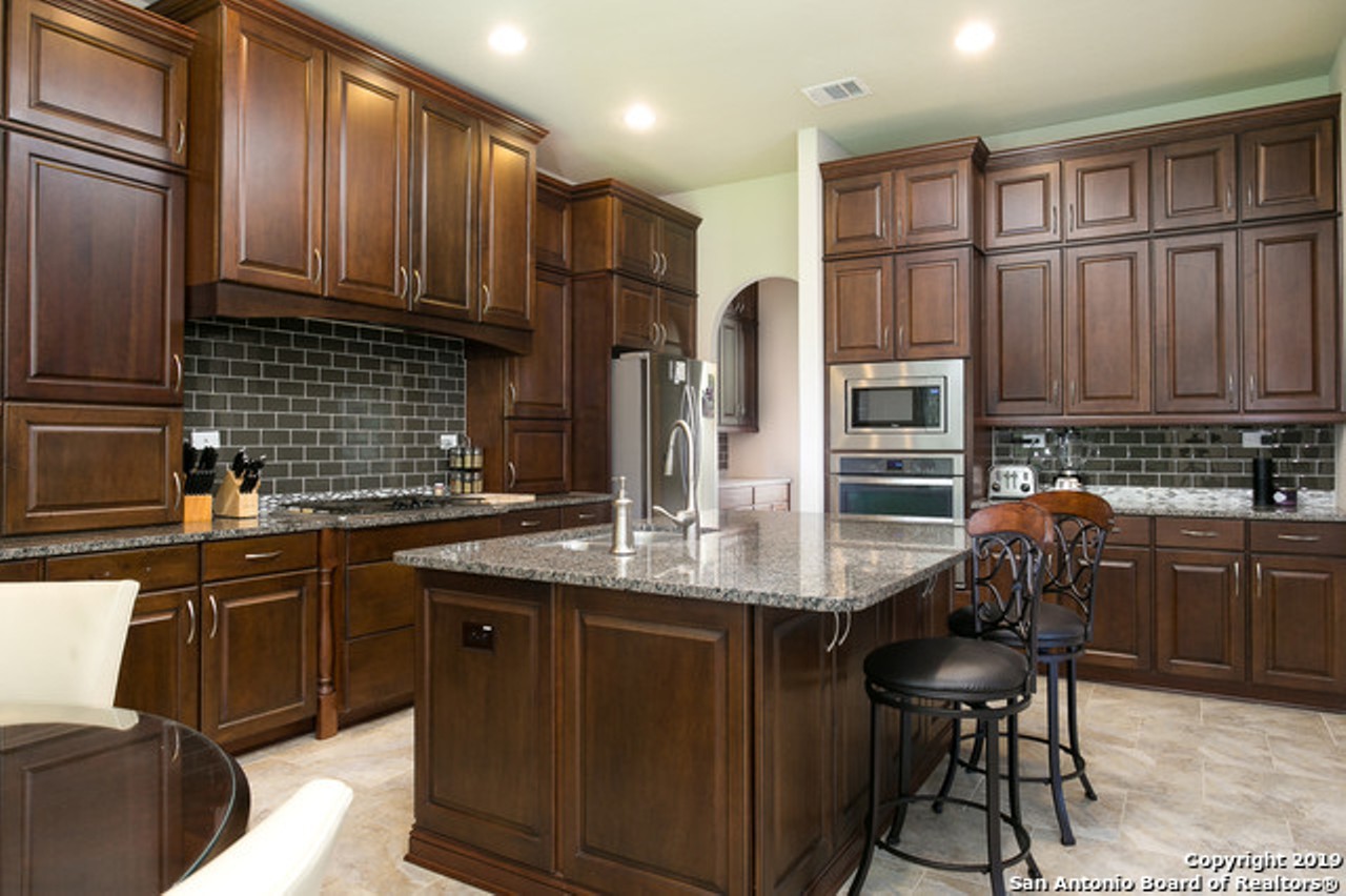 Interested buyers should note the granite countertops, custom cabinets and stainless steel appliances.