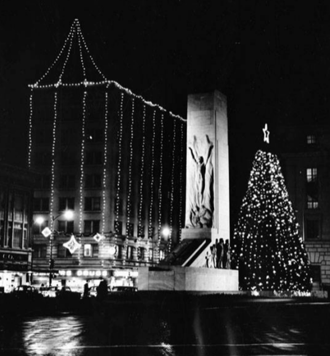 In this 1950 photograph, you can see the Christmas lights hung on the Gibbs building. Note the Christmas tree, from the city's Rotary Club, set up behind the Alamo Cenotaph.