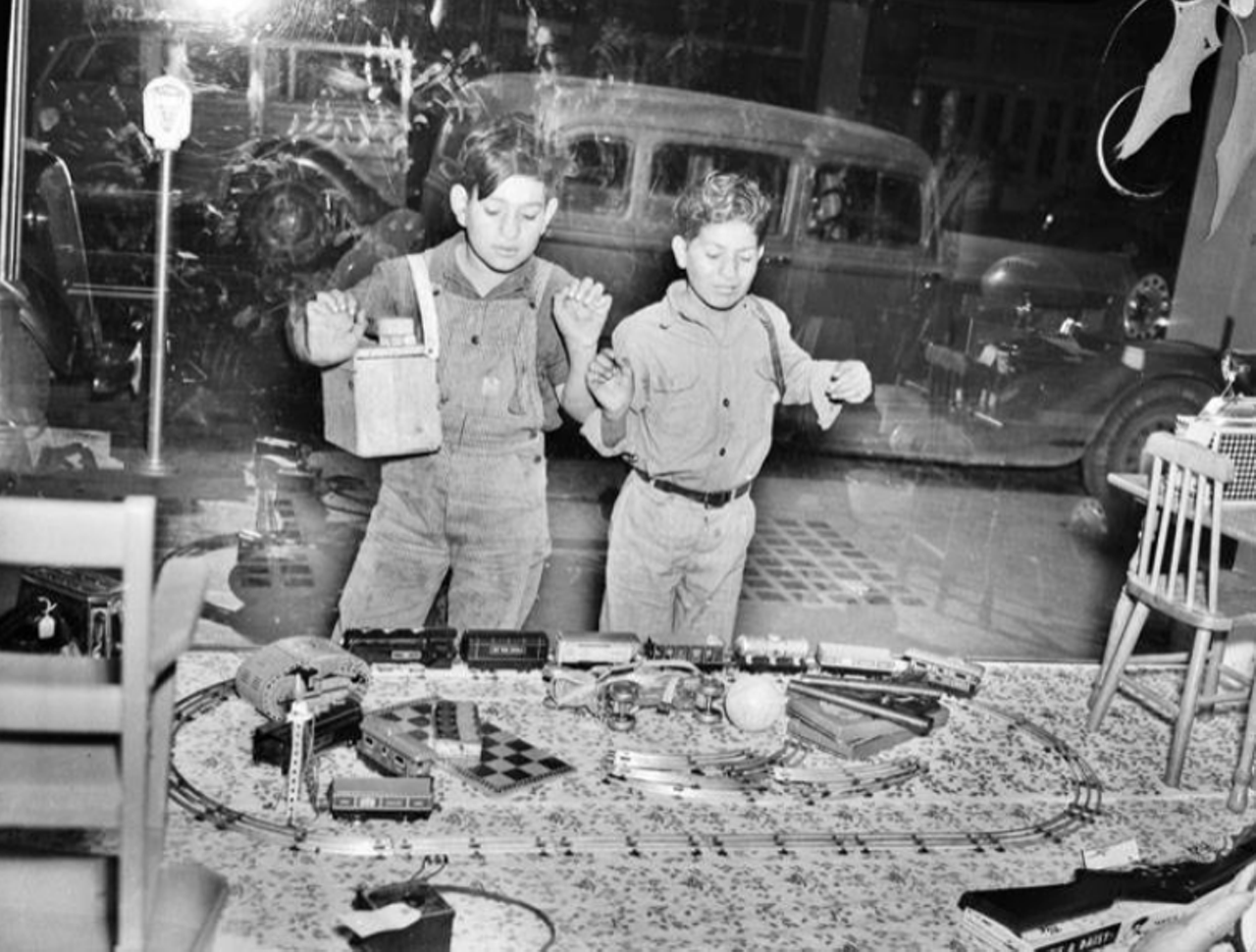 While the days of toys filling window displays may be long gone, you can peep this 1939 photo to relive that era. Here you can see two shoe shine boys (hello, child labor) getting excited about these toys.