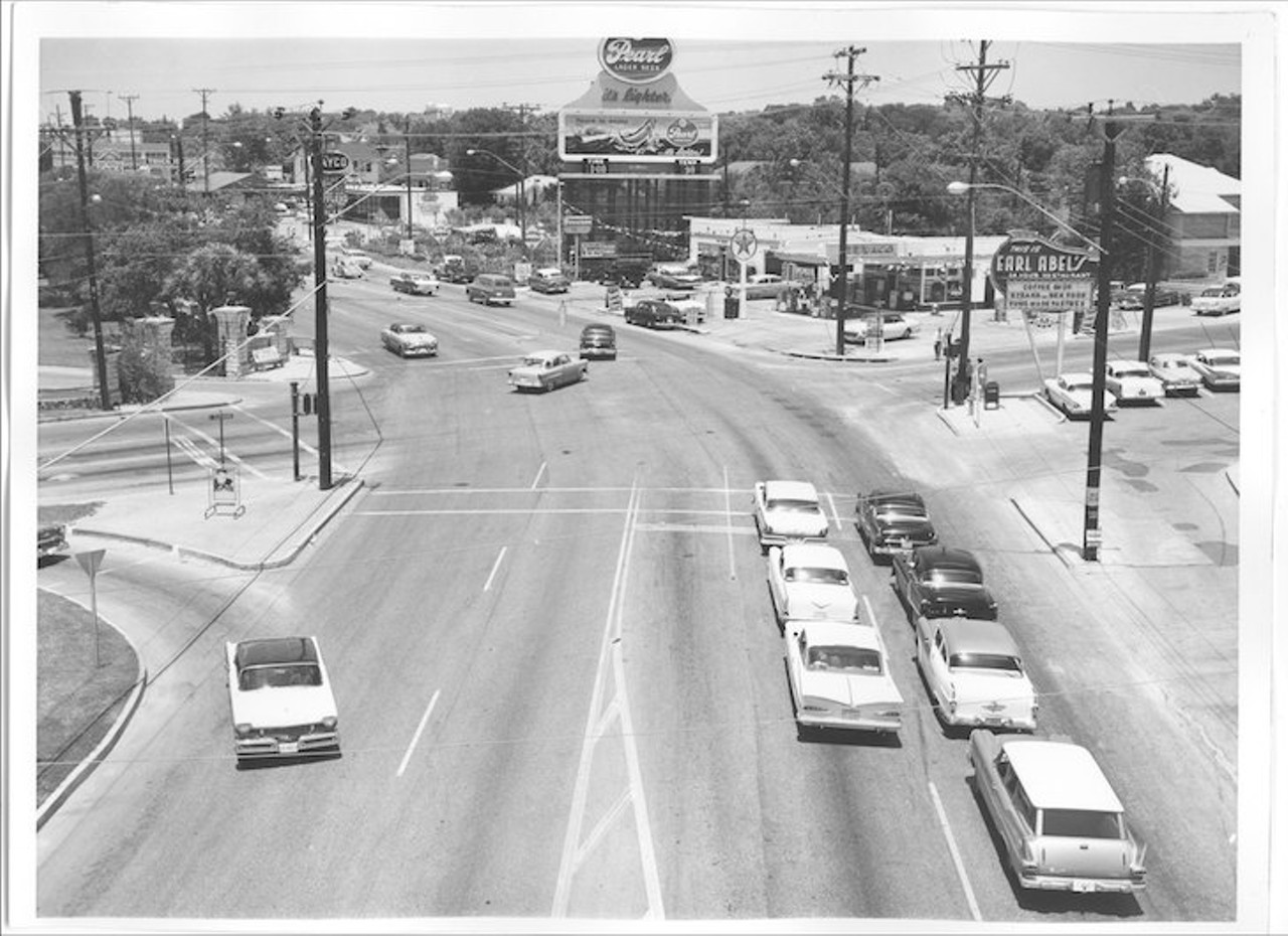 Facing north on Broadway at the corner of Hildebrand overlooking the Earl Abel's sign on the right and the Pearl Beer billboard on top.