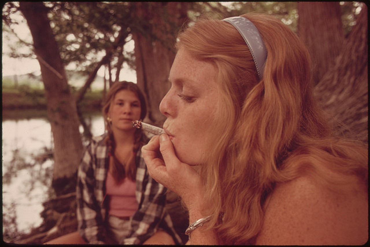 One Girl Smokes Pot While Her Friend Watches During an Outing in Cedar Woods near Leakey, Texas. (Taken with Permission)