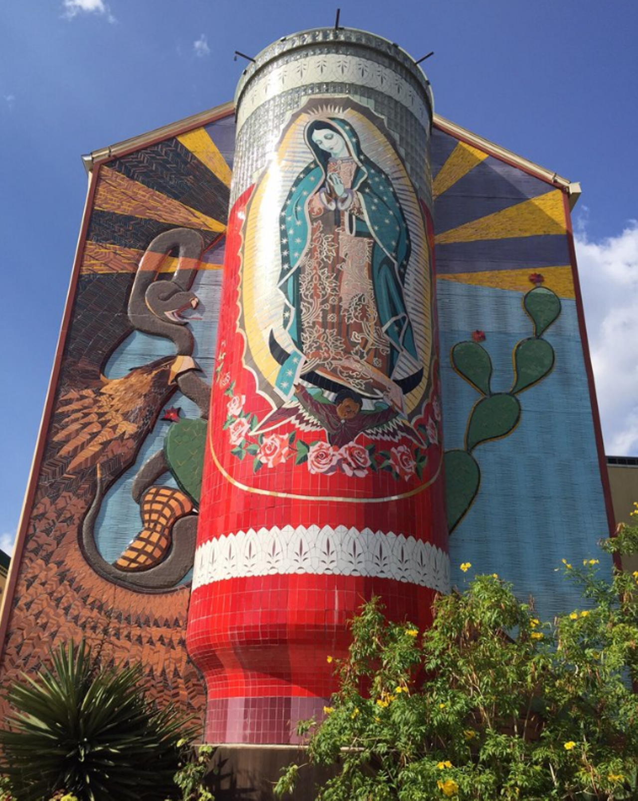 La Veladora of Our Lady of Guadalupe
1315 Guadalupe St.
Artist: Jesse Trevino, 2006
This spectacular mural features a 3D votive candle (veladora) with an eternal flame facing Guadalupe Street. Intended to serve as a beacon for the neighborhood, this mixed media mural is truly magnificent. 
Yelp/Guadalupe Cultural Arts Center