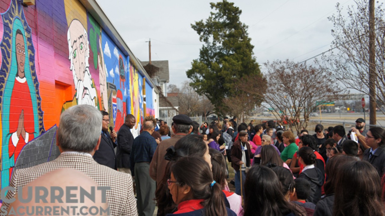 San Anto Cultural Arts&#146; John Medina addresses City Center Health Careers Charter School students and Government Hill residents who have gathered for the unveiling of &#147;El Cielo Sobre La Loma.&#148;