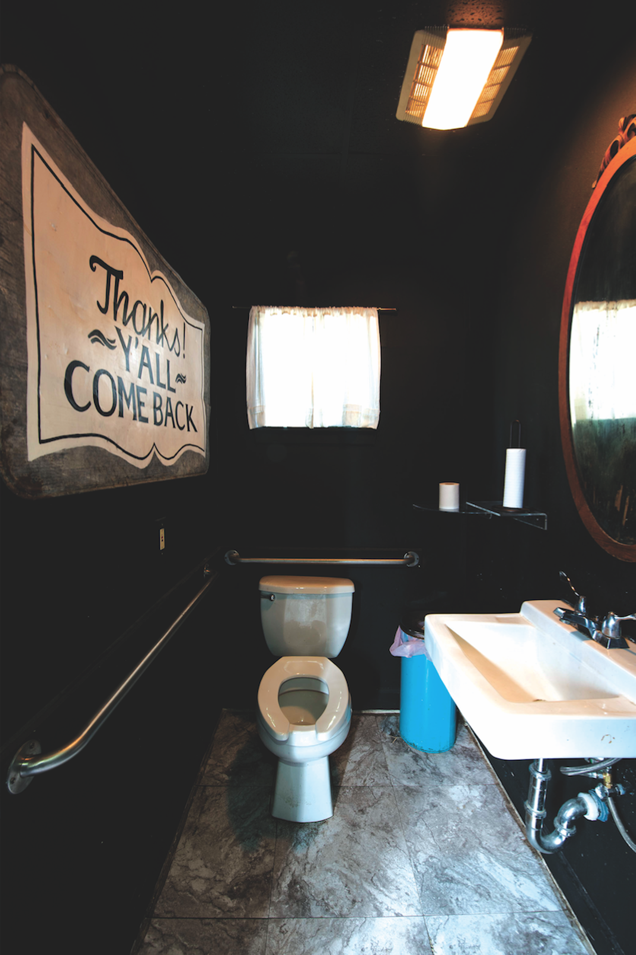 Lowcountry // Although compact, each restroom at Lowcountry is clean and private enough from the on-goings that often include live music by local country artists. The women’s restroom, painted black like the rest of the interiors, features an antique mirror and delicate lighting, capped off with a large, hand-painted metal sign. “Thanks y’all, come back,” as painted by Lowcountry’s Drew Morros (she based it off a sign in the back of a Gracious Goodness cookbook) nails this bar’s Southern charm. 318 Martinez St., (210) 560-2224, lowcountrysa.com.