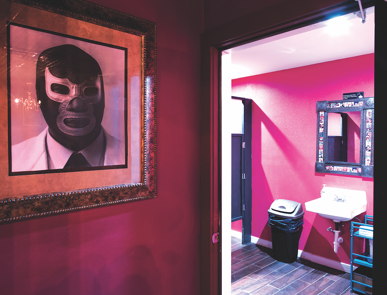El Luchador // This Southside gem blends craft beers, funky cocktails with a kitschy Mexican wrestler theme that gels with neighbors young and old. From Luchador masks hanging over the bar, to luchador paintings, posters and artwork on the walls, you’ll want to admire every single detail on your way to the restroom. With magenta-colored walls and spacious stalls, the women’s restroom is one you won’t have a problem using. There’s a long mirror to make sure your outfit is on point and mirrors at each sink that are bordered with tiles of different cartoon-wrestlers. What makes this restroom even better, is a basket full of feminine products available gratis for those pesky emergencies. The men’s restroom is smaller but has the same wrestler-lined tile and a clean stall with a “El Demonio Azul” wrestler poster watching your six. 622 Roosevelt Ave., (210) 272-0016, facebook.com/luchadorbarsa.