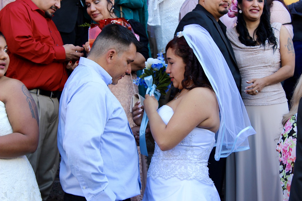 Alondra and Christopher Garcia exchanging rings during the ceremony.