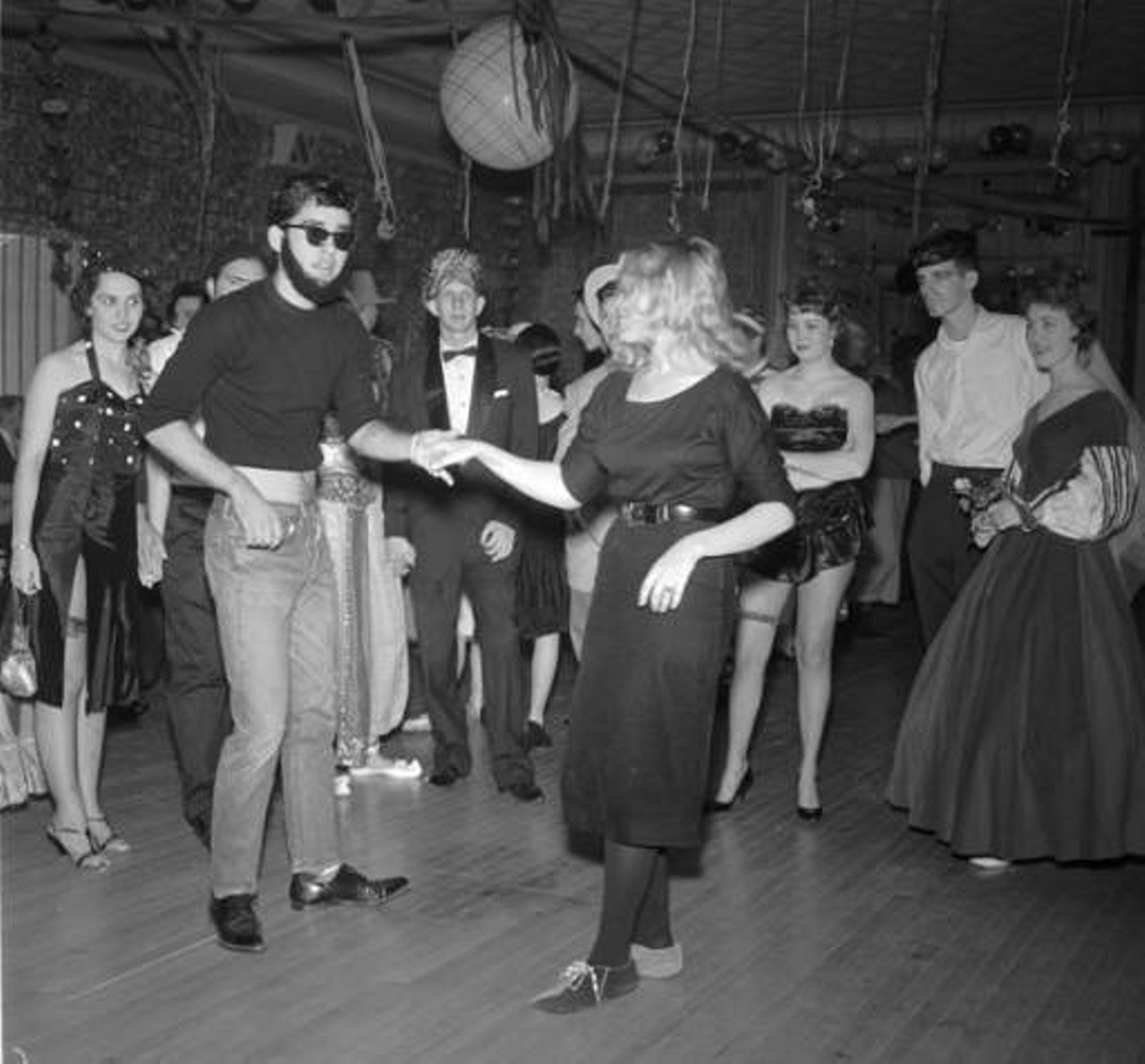 Dancers at Record Hop at Oak Hills Country Club, 1959
While sock hops were usually held in gyms and the term was coined for having to remove your shoes before dancing, “record hops” were a dance where you didn’t have to take off your shoes, usually because it wasn’t held on varnished floors.
Photo via Zintgraff Studio Photo Collection