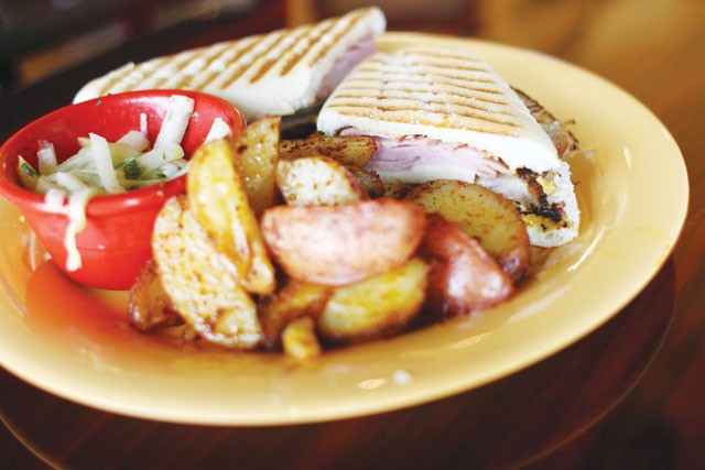A Cuban panini with baked potato wedges from Calypso. - MICAHEL BARAJAS