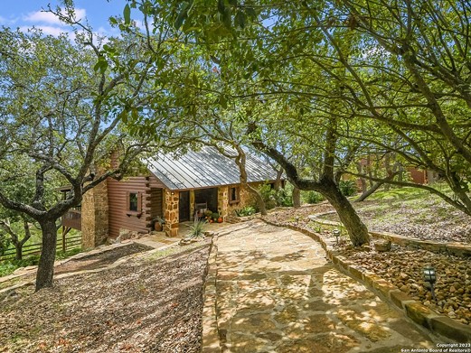 A log-cabin resort for sale in San Antonio is built on the county's highest point