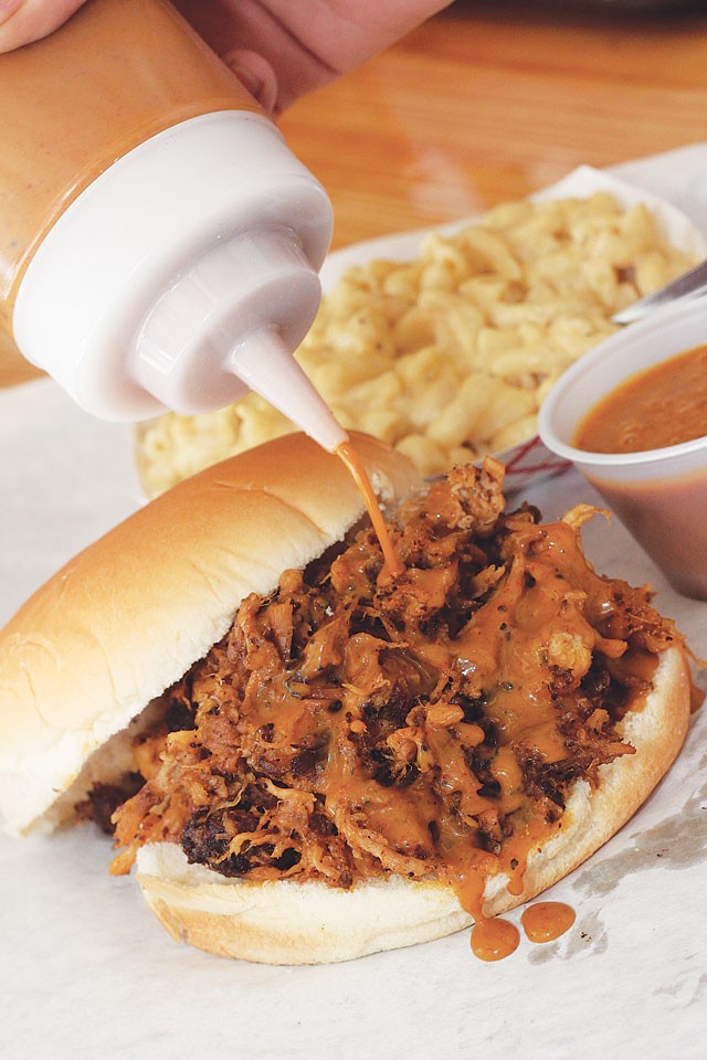 A pulled pork sandwich drizzled with Carolina sauce from Meat Market Barbecue. - CHUCK KERR