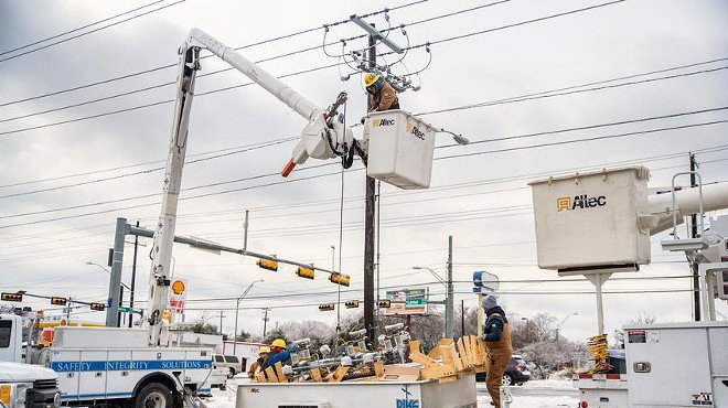 Electrical workers repair a power line in Austin on Feb. 18, 2021, after a powerful winter storm caused massive blackouts across Texas.