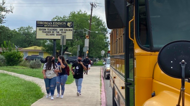 Masked students approach Thomas Edison High School.