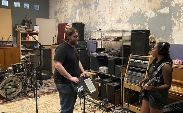 Studio E owner Brant Sankey (left) talks to Anelisa Huff, bassist for Daphne Kills Fred during a recording session.
