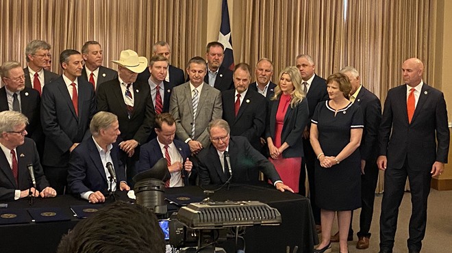 Their master's voice: Gov. Greg Abbott listens intently as NRA chief Wayne LaPierre speaks during a 2021 ceremony where the governor signed seven bills easing firearms regulations.