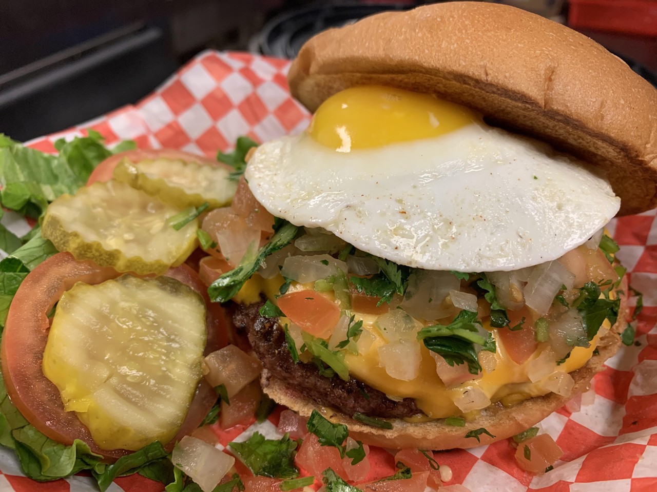 Big'z Burger Joint
Dine-in and Curbside, Multiple Locations, bigz-burgerjoint.com
Cascarone Burger, $8, 1/2 lb. certified Angus beef burger topped with cheddar cheese, pico de gallo and a sunny side up fried egg. 
Photo courtesy of Big’z Burger Joint
