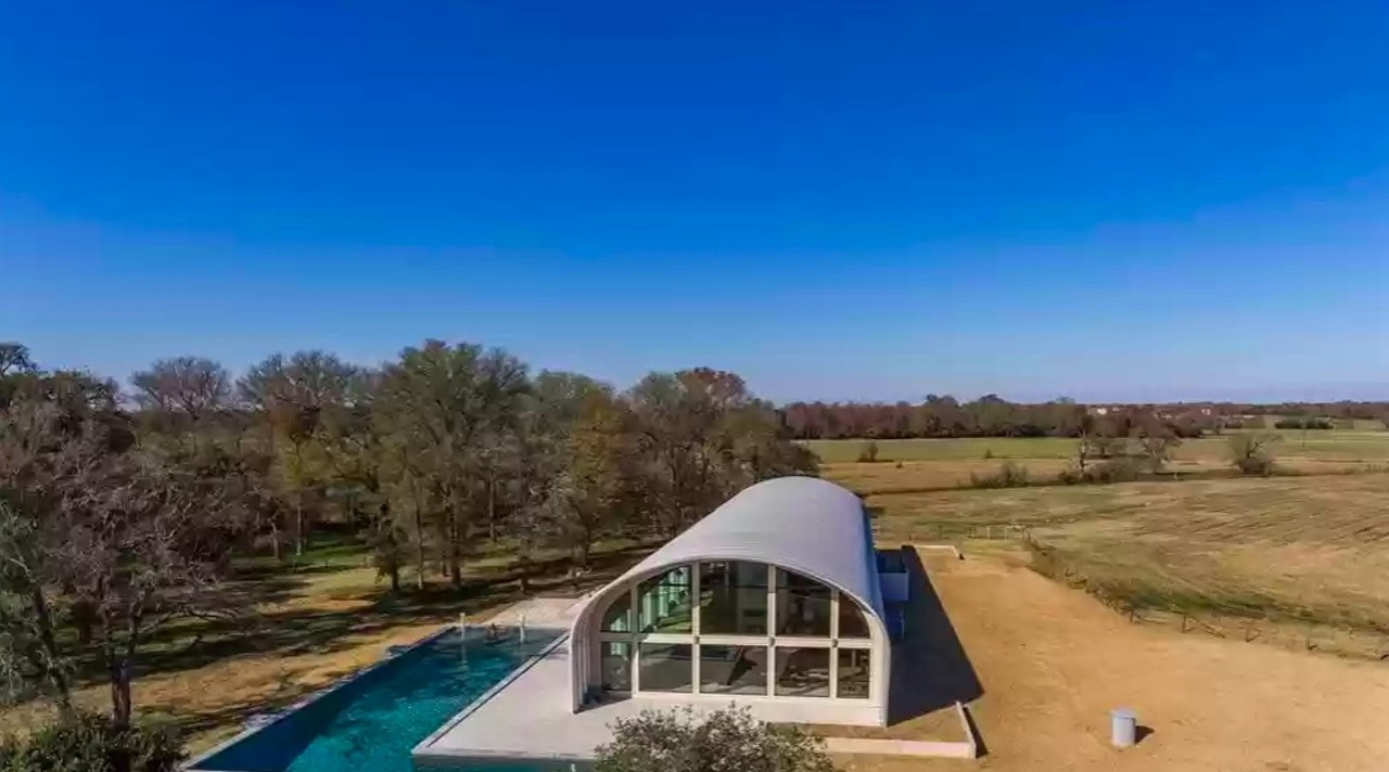 An east Texas House for sale looks like an airplane hangar with a wraparound swimming pool