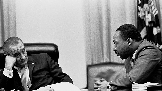 Martin Luther King Jr. makes a point to President Lyndon B. Johnson in the White House Cabinet Room.