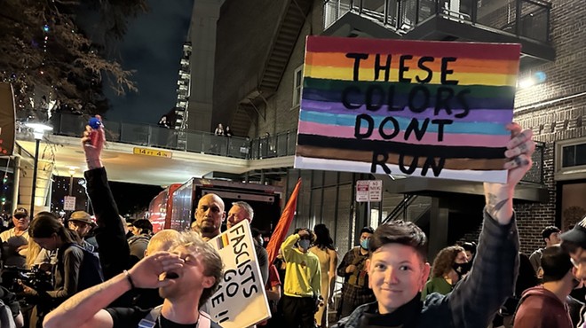 Protesters hold pro-LGBTQ+ signs in downtown San Antonio after a far-right group rallied against a drag performance.