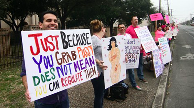 Planned Parenthood supporters hold signs at a San Antonio rally in 2017.