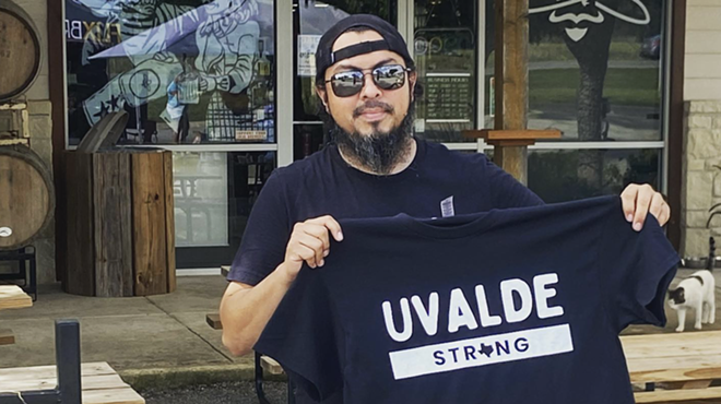 Johnny Oliver, co-owner of Bandera Brewery, shows off a Uvalde Strong T-shirt at this weekend's benefit.