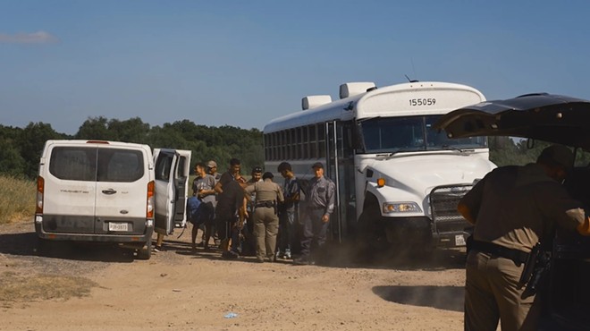 Migrants who have surrendered to Border Patrol agents are processed by state troopers before being transported to a detention facility in Eagle Pass on July 14, 2023.