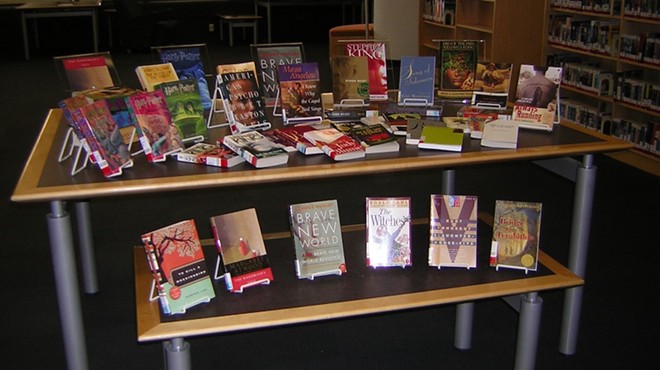 Banned books are arranged on display at a library event.